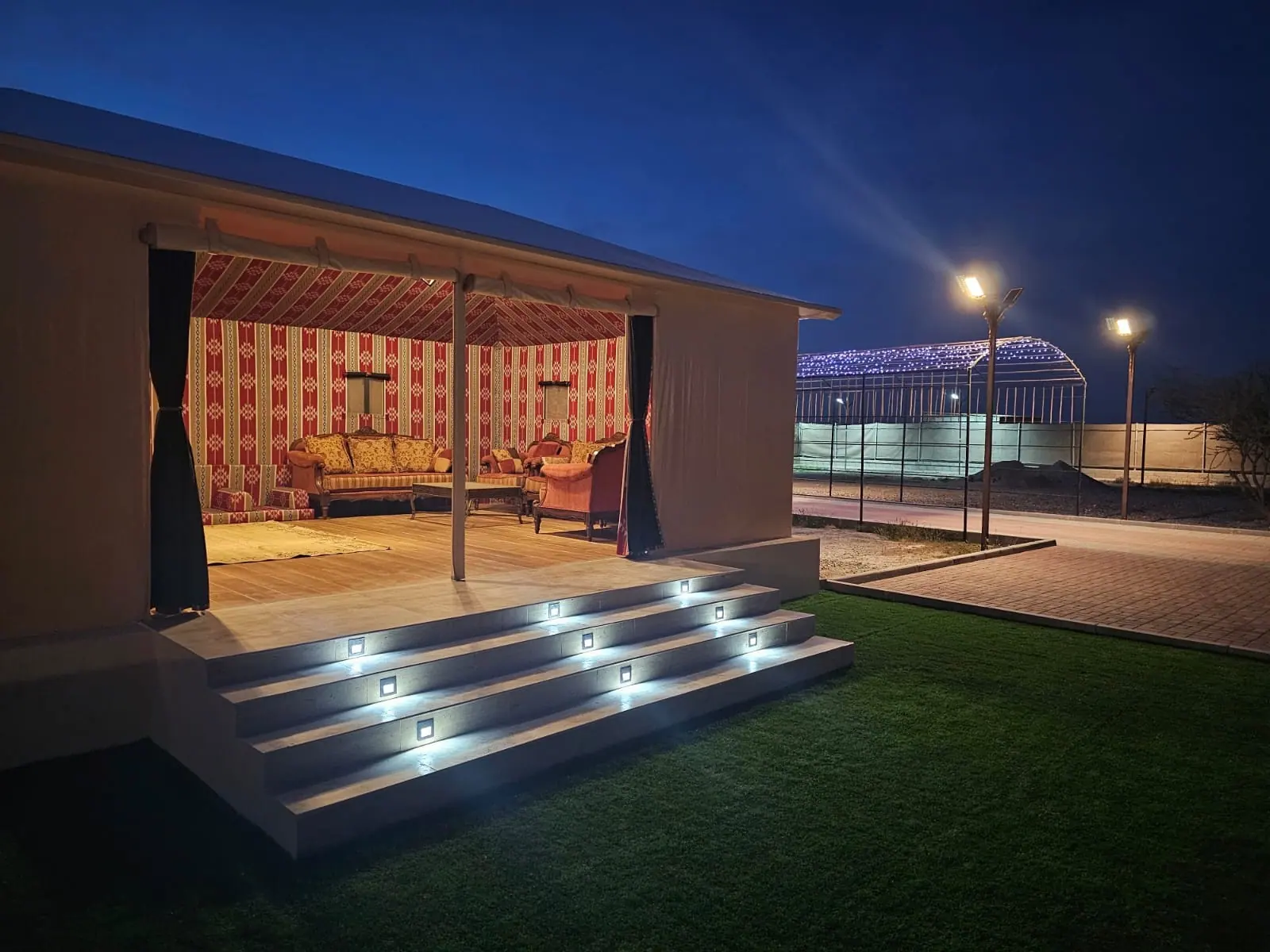 Peace Retreat outdoor majlis under a lit gazebo at night