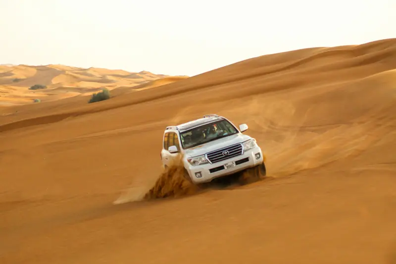 Four-wheel drive climbing the red sand dunes on a Dubai desert safari